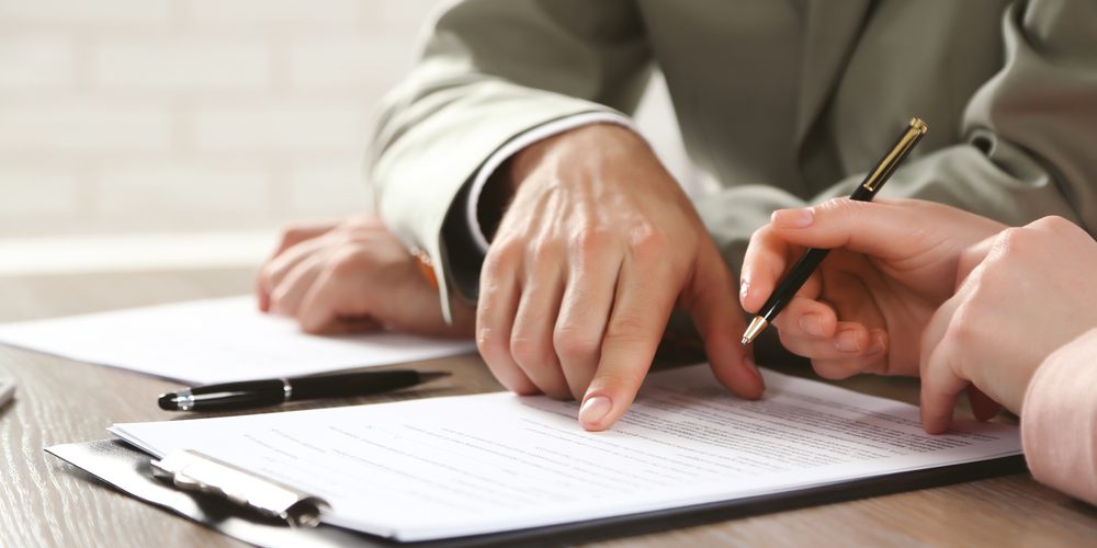 Human,Hands,Working,With,Documents,At,The,Desk,Closeup