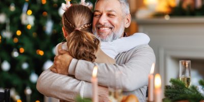 Little,Girl,Granddaughter,Hugging,Embracing,Happy,Smiling,Grandfather,During,Christmas
