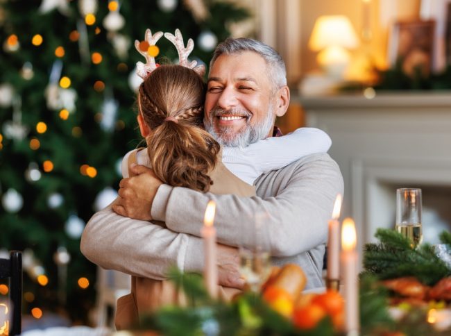 Little,Girl,Granddaughter,Hugging,Embracing,Happy,Smiling,Grandfather,During,Christmas